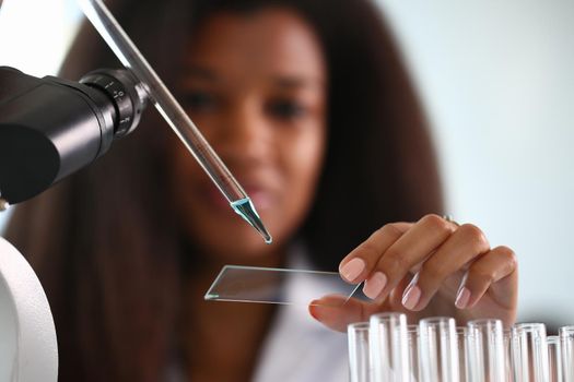 A male chemist holds test tube of glass