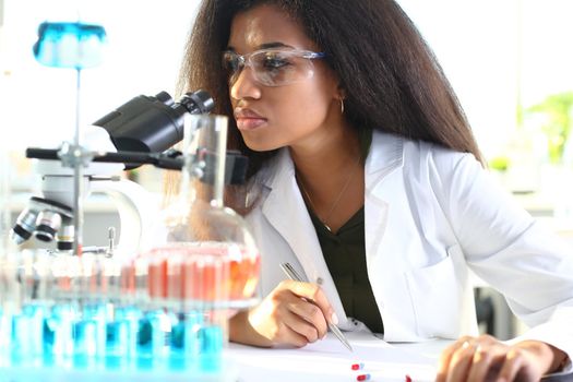 Black woman scientist student chemist in protective