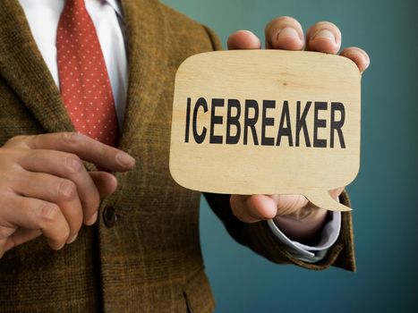 Man in suit shows Icebreaker sign on the plate.