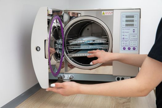 Sterilizing medical instruments in autoclave in dental office