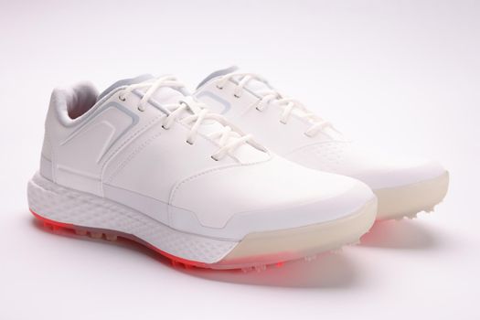 Fashionable women's white sneakers with laces on a paper sheet