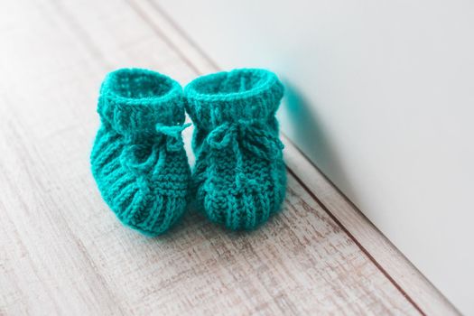 Mint knitted booties for a child.