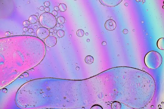 Holographic colorful abstract background with oil drops on water