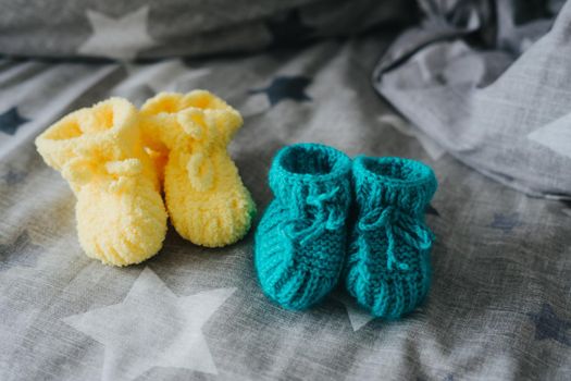 Mint and yellow knitted booties for a child.
