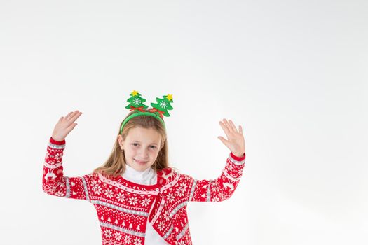 Portrait of excited funny funky schoolchild dancing in christmas costume with headband isolated on white background.Ready For Christmas party.Merry Christmas presents shopping sale concept.