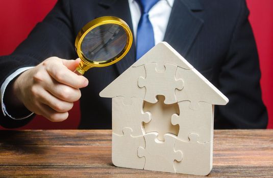 Man studies the missing piece in puzzles house. Purchase or construction comfortable dream home. Mortgage loan purchase real estate. Property valuation. Legal deal, transparency of purchase agreement