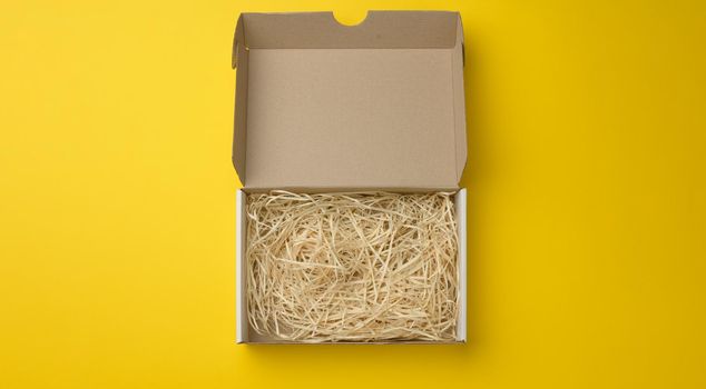 rectangular open corrugated paper box with sawdust inside
