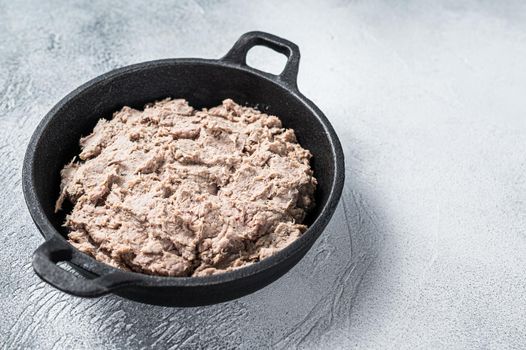 Duck Rillettes de Canard in a pan. White background. Top View. Copy space