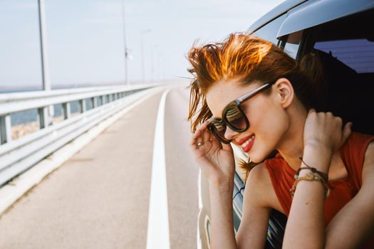 pretty woman in sunglasses rides in a travel car