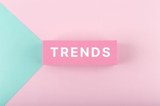 Trends single word written on pink rectangle on light multicolored pink and aqua blue background
