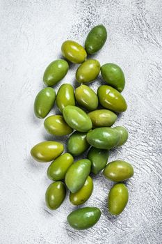 Fresh Green big olives on a table. White background. Top view