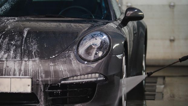 Washing a luxury car in the suds - telephoto