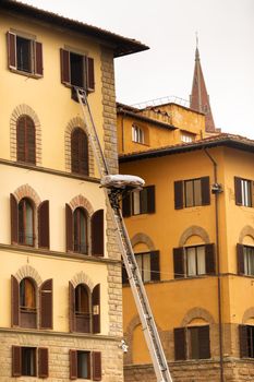 Lifting cargo to the top floor using a large staircase in the center of Florence.Italy.Tuscany
