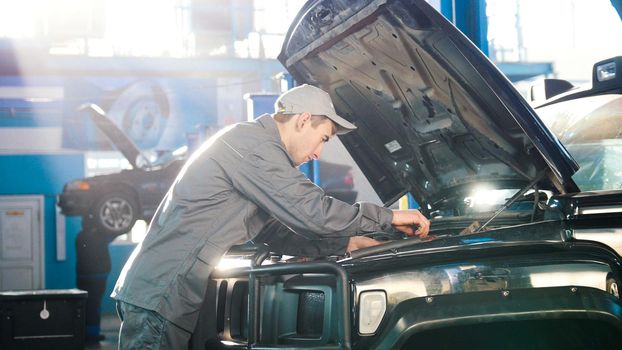Mechanic in car service - repairing for luxury SUV