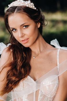 Close-up portrait of an Elegant bride in a white dress in nature in a nature Park.Model in a wedding dress and gloves .Belarus