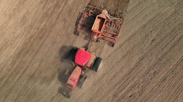 Tractor with a unit that processes dusty, arid soil
