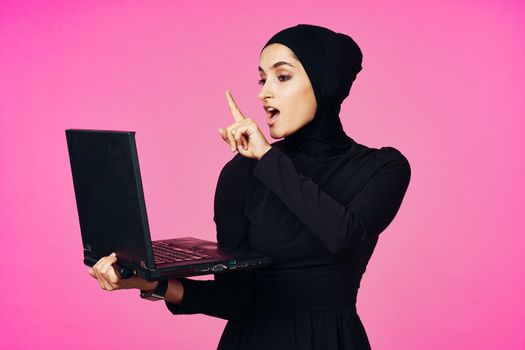 cheerful muslim woman with laptop education student internet technology. High quality photo