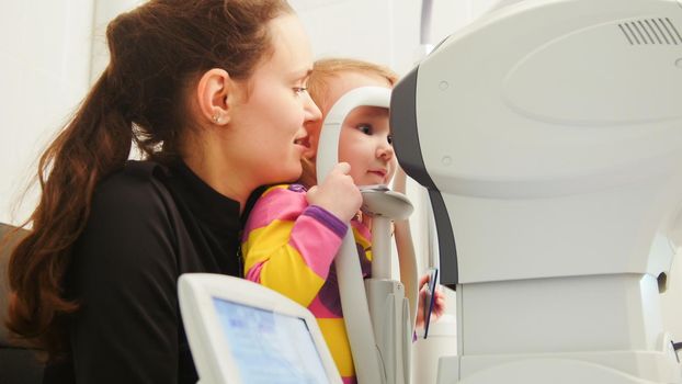 Children ophthalmology - optometrist Checks Child's Eye