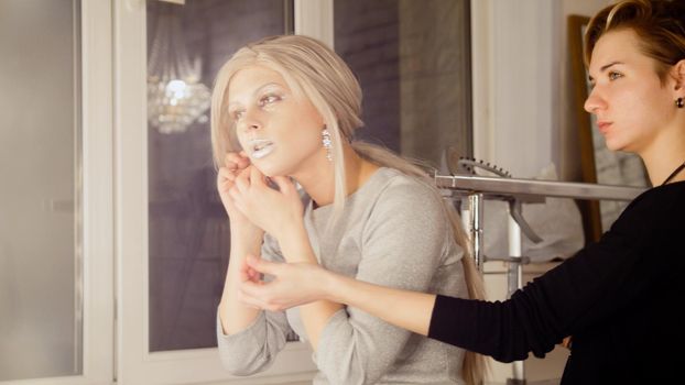Beauty shop: attractive young woman model wear earrings