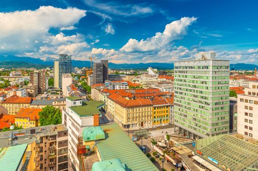 Ljubljana - June 2020, Slovenia: Aerial panorama of Ljubljana city center with modern and historical buildings and picturesque cumulus clouds in the sky