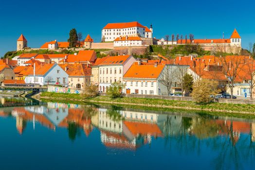 Ptuj - March 2021, Slovenia: Beautiful view of the old Slovenian town of Ptuj reflected in the water