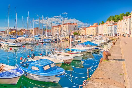 Piran - June 2020, Slovenia: Colorful boats lying on the water in the harbor of the ancient Slovenian town of Piran