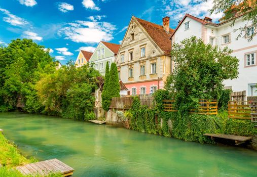 Steyr - July 2020, Austria: A row of residential buildings and a canal with water in the medieval Austrian city of Steyr