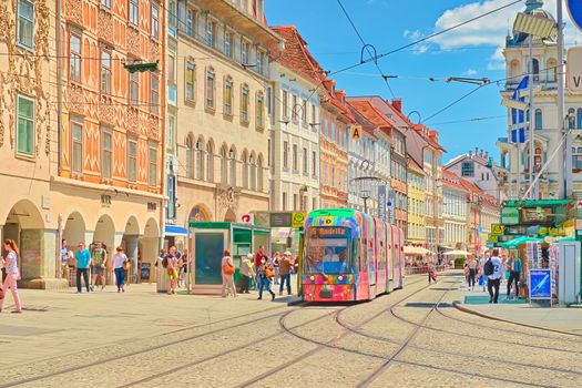 Graz - June 2020, Austria: View of the city center of Graz with modern tram, tram lines, tram station and beautiful old buildings in the traditional architectural style