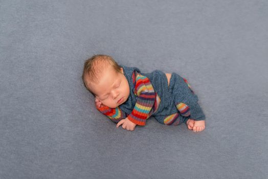 Hairy newborn in striped outfit