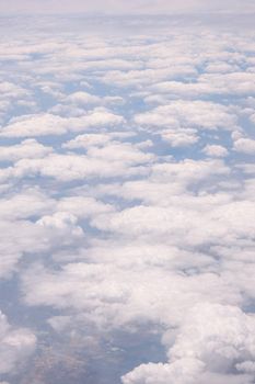 Airplane flight. View from the window of the plane. Airplane, Aircraft. Traveling by air. Airplane Window View Above the Clouds Amazing golden fluffy clouds moving softly