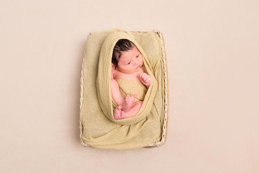 Wrapped black-haired baby basket, topview
