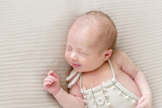 Emotions of an infant in costume sleeping, closeup