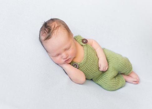 infant wearing summer green knitted costume