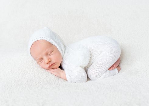 Infant boy in white bodysuit