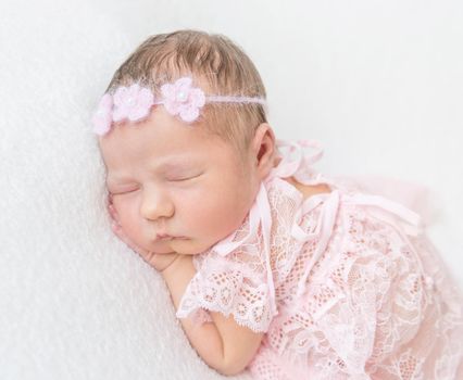 princess baby napping in laced pink suit