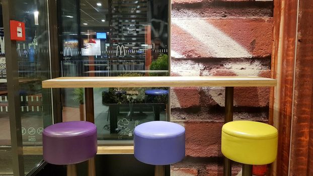Ukraine, Kiev - August 19, 2019: McDonald's restaurant interior. McDonald's is the world's largest fast food restaurant chain based in the USA. Interior with tall tables and colored bar stools