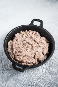 Duck pate Rillettes de Canard in a pan. White background. Top View. Copy space