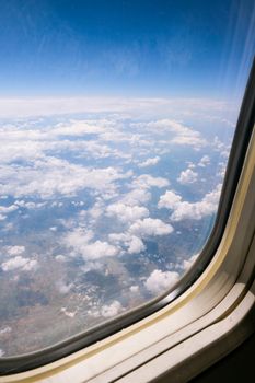 Airplane flight. View from the window of the plane. Airplane, Aircraft. Traveling by air. Airplane Window View Above the Clouds Amazing golden fluffy clouds moving softly