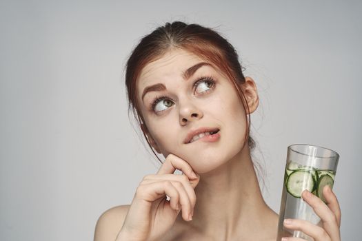 woman with cucumber drink health vitamins close-up. High quality photo