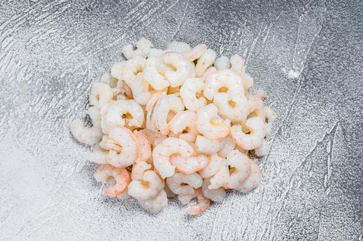 Peeled raw Shrimps, Prawns on a table. White background. top view