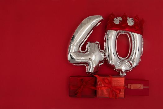 Balloon 40 in crown on dark red background flat lay