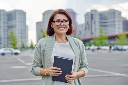 Outdoor portrait of business woman 40s of age