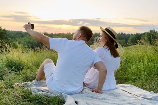 Beautiful adult couple together taking selfie photo on smartphone