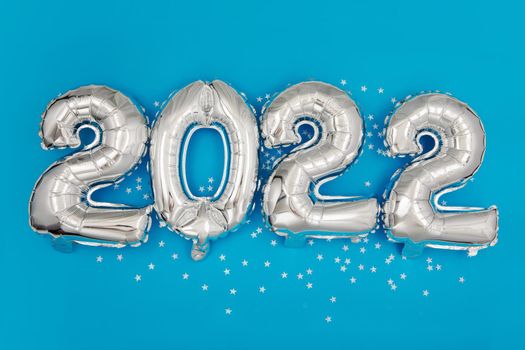 Silver balloons showing 2022 year on blue background