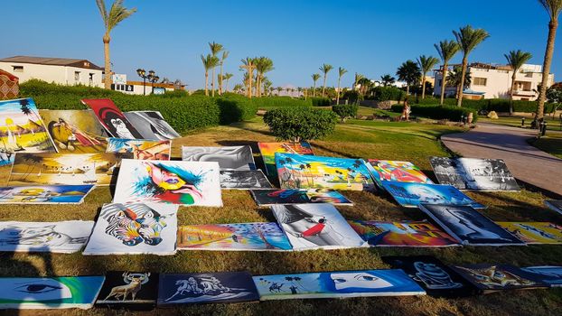 Egypt, Sharm El Sheikh - June 20, 2019: paintings for sale on the street in a park in the Amway Hotel. Flea market and street gallery of art and creativity.