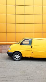 Ukraine, Kiev - March 27, 2020: Yellow Transporter in yellow on a background of a yellow building.