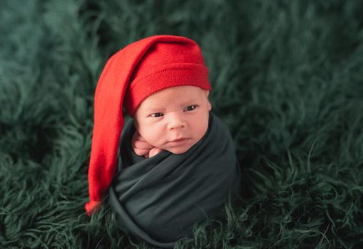Cute baby in red santa hat sleeping