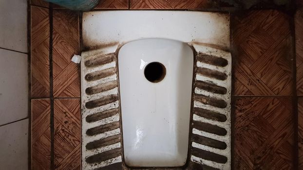 dirty old and dusty toilet in a public abandoned building. Ruined hygiene room.