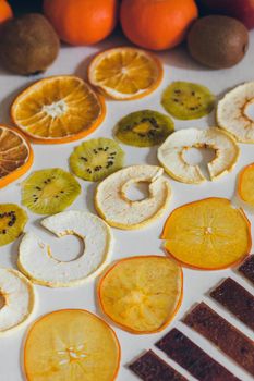 Dried homemade healthy fresh dehydrated slices of fruits. Fruit chips, natural raw vegan organic snack. Healthy food concept.