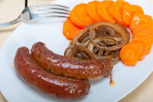 beef sausages cooked on iron skillet 